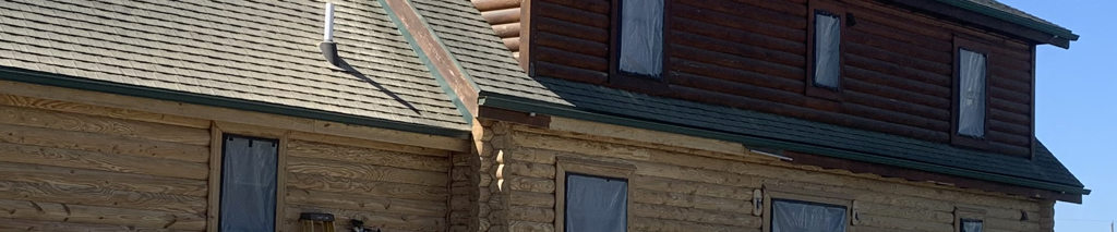 contractors media blasting a log home