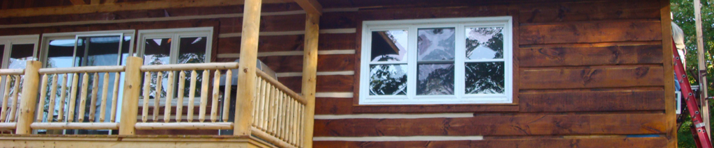 Log Cabin Chinking Contractors log home chinking applied by contractor standing on ladder